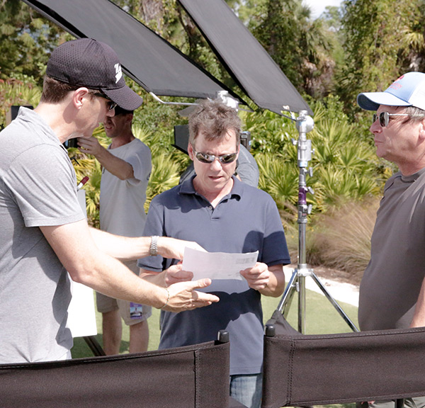 Three people looking at script